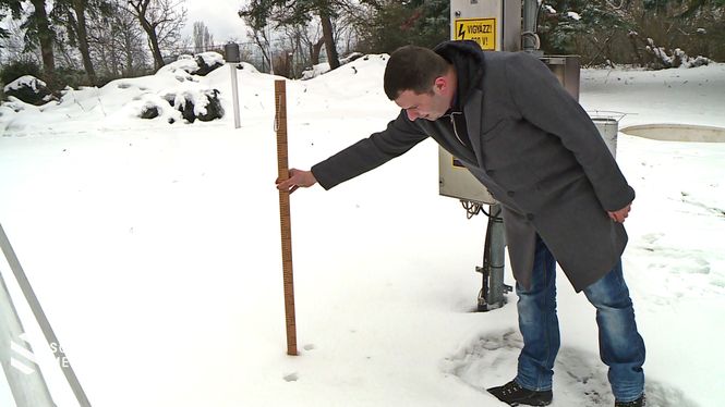 Kiss Márton méri a hó szintjét