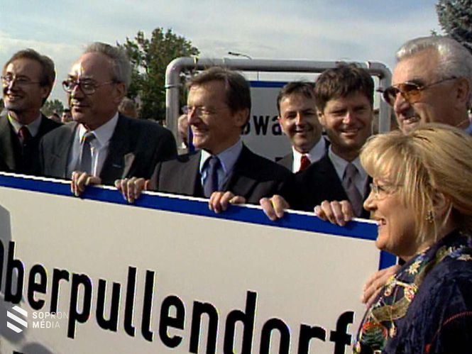 Karl Stix, Burgenland tartományfőnöke (b2), Wolfgang Schüssel kancellár (b3) és Kulmann Ernő, Felsőpulya polgármestere (jobb szélen) A felszerelésre váró Oberpullendorf/Felsőpulya táblával 2000. július 13-án Szabadbáránd/Großwarasdorf település határában.